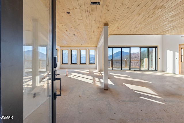 interior space with wooden ceiling and a mountain view