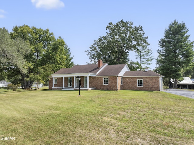 single story home with a front lawn and a porch