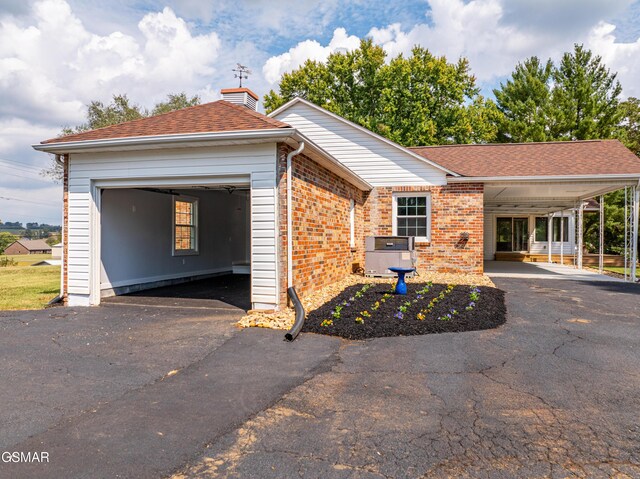 view of front of property featuring a garage and central AC unit