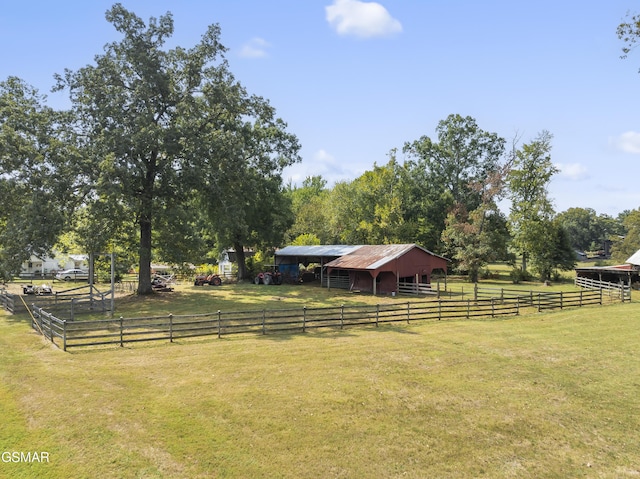 view of yard with a rural view and an outbuilding