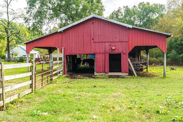 view of outbuilding featuring a yard