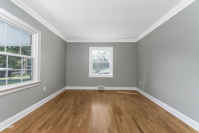 unfurnished room with hardwood / wood-style floors and ornamental molding