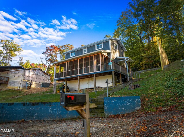 rear view of property with a sunroom