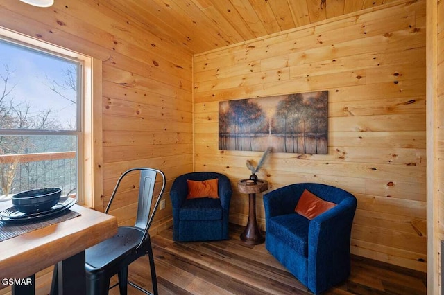 living area with wood ceiling, dark wood-type flooring, and wood walls