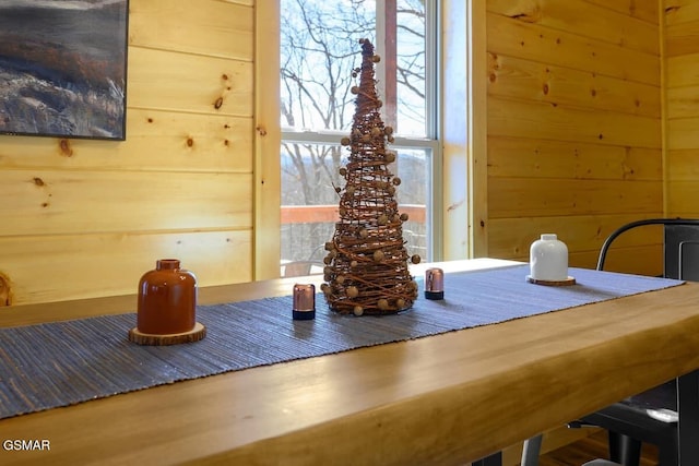 dining area featuring wooden walls