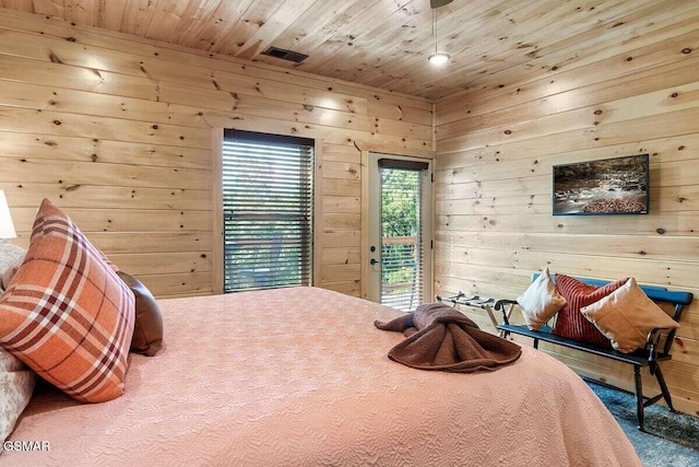 carpeted bedroom with wood walls, access to exterior, and wooden ceiling