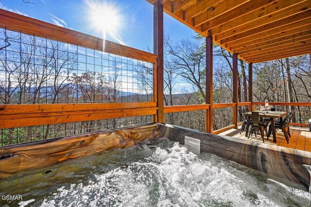 wooden terrace featuring a hot tub