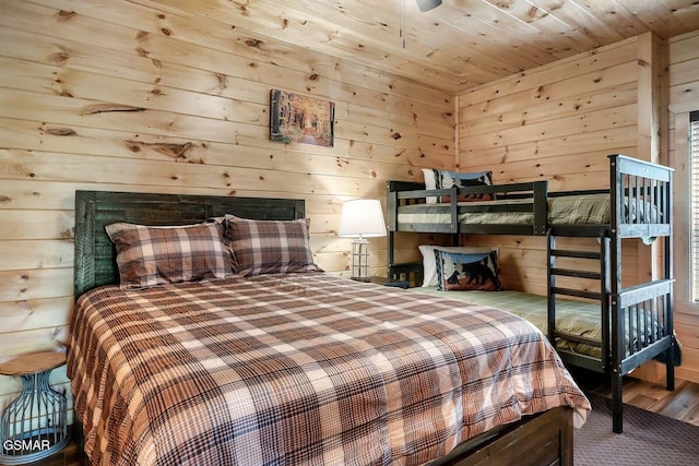 bedroom with wooden ceiling and wood walls