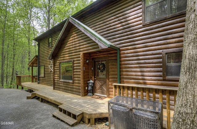 3050 Headrick Dr, Sevierville, TN 37862 - property entrance featuring a wooden deck and log veneer siding