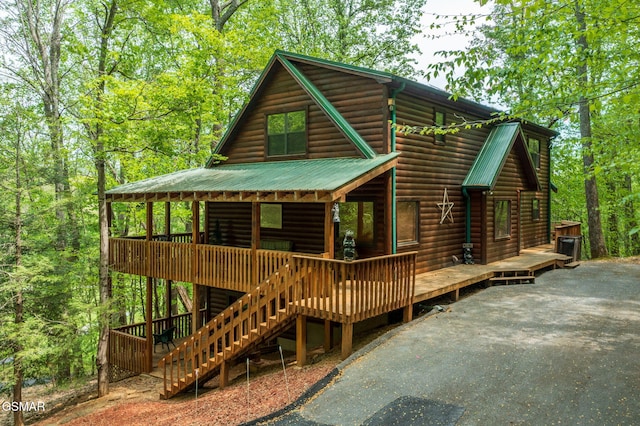 3050 Headrick Dr, Sevierville, TN 37862 - back of property with a wooded view, metal roof, log veneer siding, and stairway