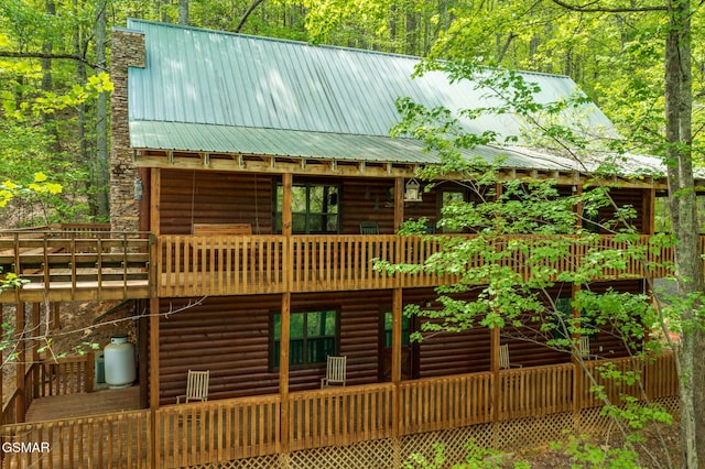 3050 Headrick Dr, Sevierville, TN 37862 - back of property with a wooden deck and metal roof