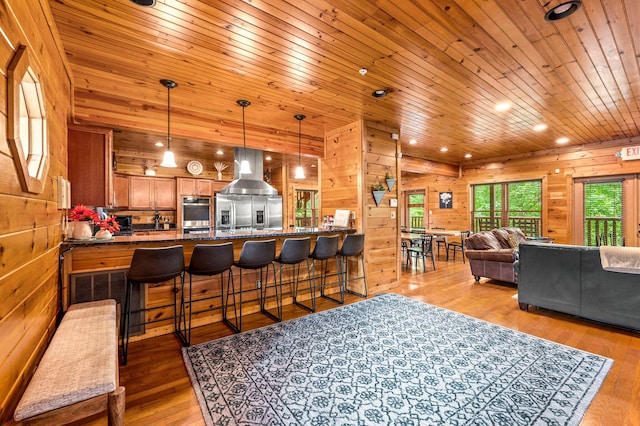 living room with wood walls, wooden ceiling, and light hardwood / wood-style flooring