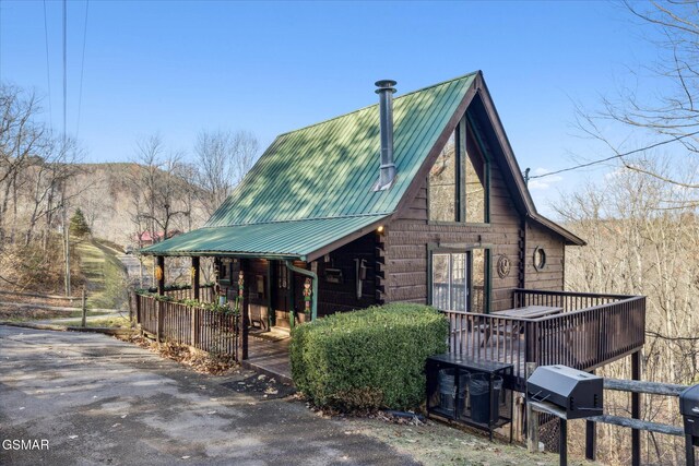 view of side of home featuring metal roof