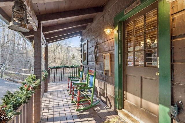wooden terrace featuring covered porch