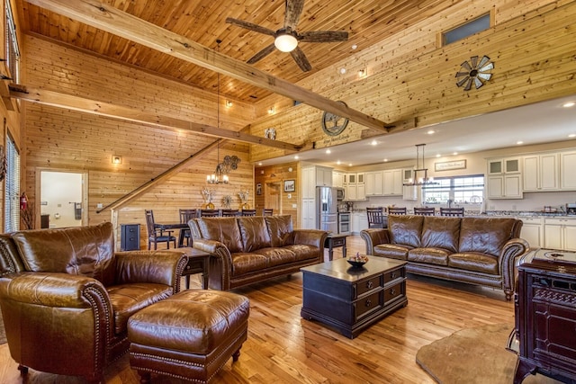 810 Oakley Way, Gatlinburg, TN 37738 - living area with wood walls, a towering ceiling, ceiling fan, light wood-style floors, and beamed ceiling