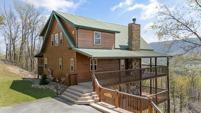 2851 Indigo Ln, Sevierville, TN 37862 - rear view of house with a lawn, a chimney, and metal roof