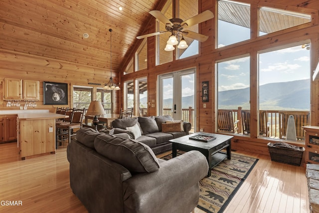 2851 Indigo Ln, Sevierville, TN 37862 - living room with a ceiling fan, light wood-style floors, a mountain view, wood ceiling, and high vaulted ceiling