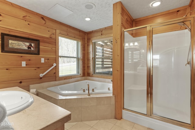 2851 Indigo Ln, Sevierville, TN 37862 - full bathroom with tile patterned floors, a garden tub, a sink, and a stall shower