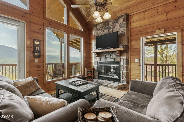 2851 Indigo Ln, Sevierville, TN 37862 - living area with a mountain view, wood walls, wood finished floors, ceiling fan, and a fireplace