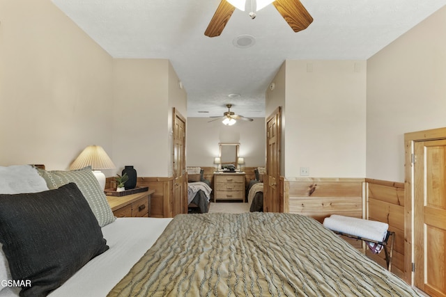2851 Indigo Ln, Sevierville, TN 37862 - bedroom with wainscoting, wood walls, and a ceiling fan