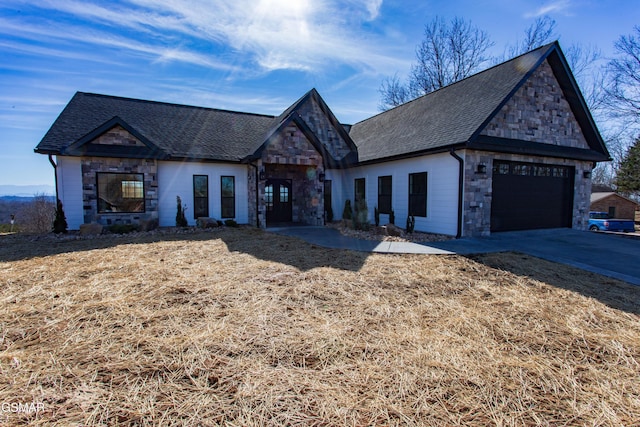 french provincial home featuring concrete driveway, a garage, stone siding, and a shingled roof