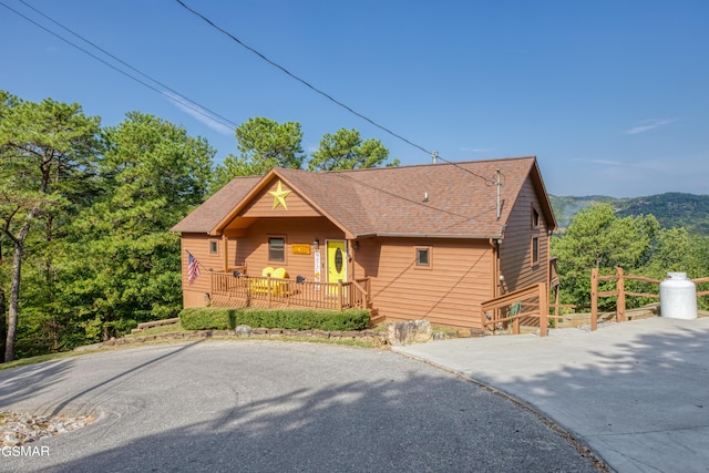 chalet / cabin with a shingled roof