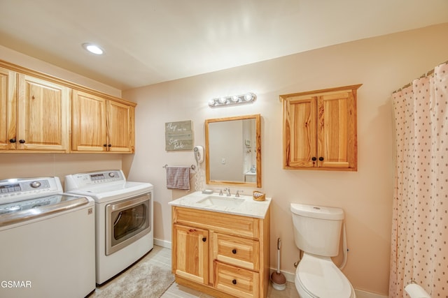 laundry room featuring laundry area, a sink, baseboards, and separate washer and dryer