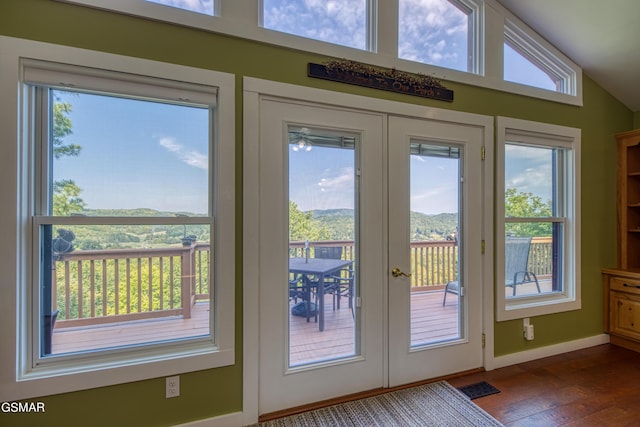 doorway featuring baseboards, visible vents, wood finished floors, vaulted ceiling, and french doors