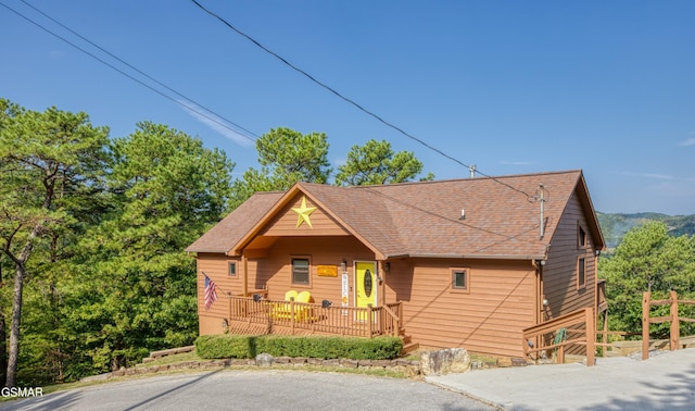 rustic home with roof with shingles