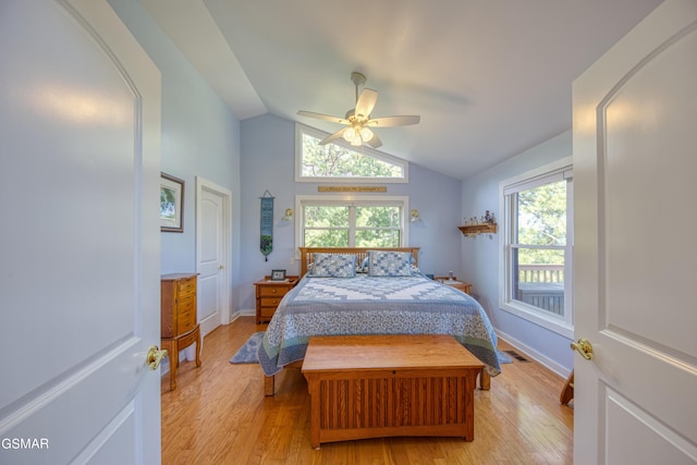 bedroom with lofted ceiling, light wood finished floors, baseboards, and a ceiling fan