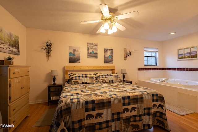 bedroom with hardwood / wood-style floors and ceiling fan