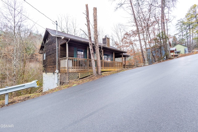 log home featuring a porch