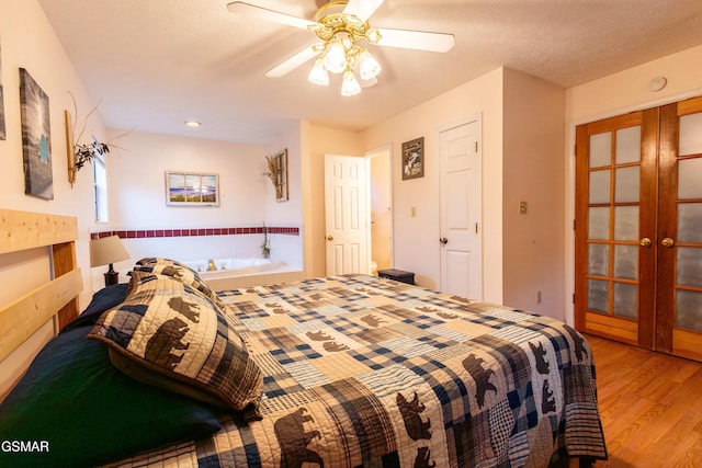 bedroom featuring french doors, a textured ceiling, ceiling fan, and light hardwood / wood-style floors