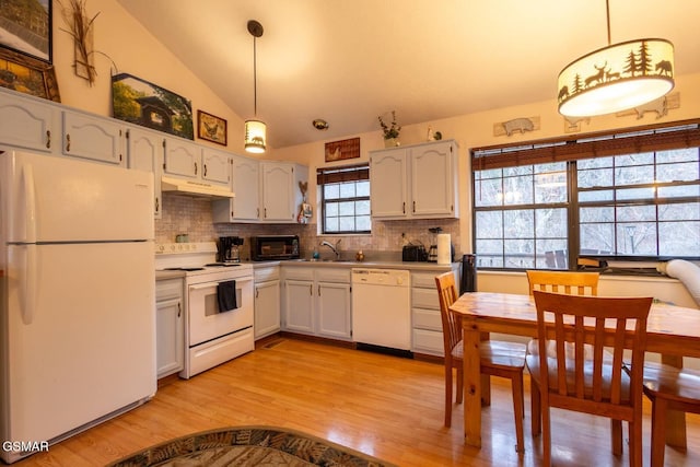 kitchen featuring vaulted ceiling, white cabinets, decorative backsplash, hanging light fixtures, and white appliances