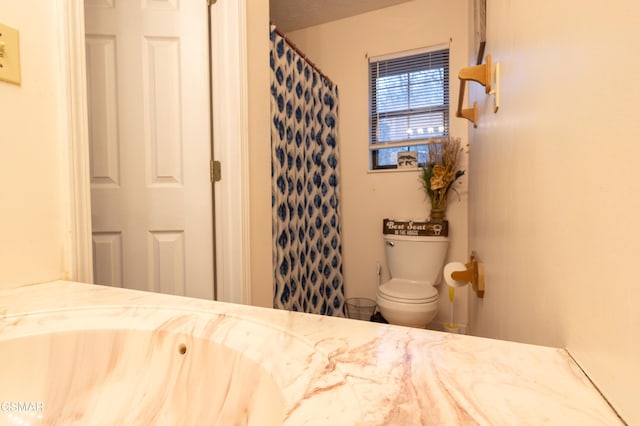 bathroom featuring vanity, a textured ceiling, toilet, and a shower with shower curtain