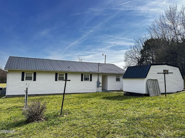 rear view of house with a lawn