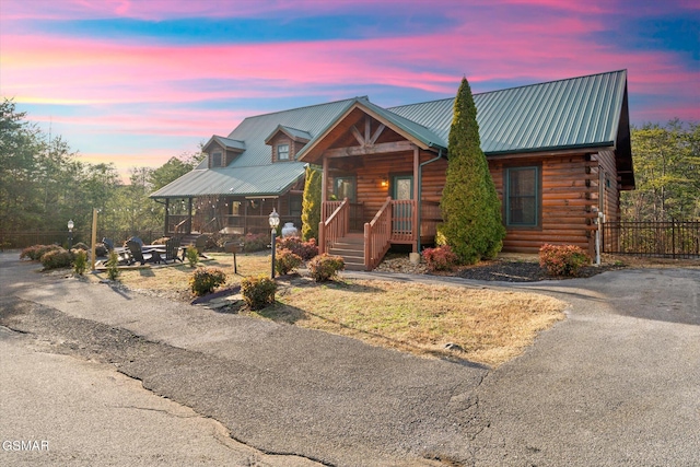 log-style house featuring a porch