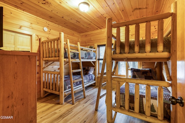 bedroom with light hardwood / wood-style floors and wooden ceiling