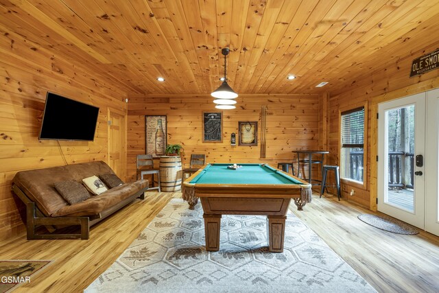 game room featuring wood walls, light wood-type flooring, wooden ceiling, and billiards