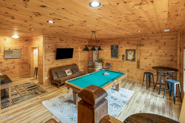 rec room with light wood-type flooring, wooden walls, wooden ceiling, and billiards