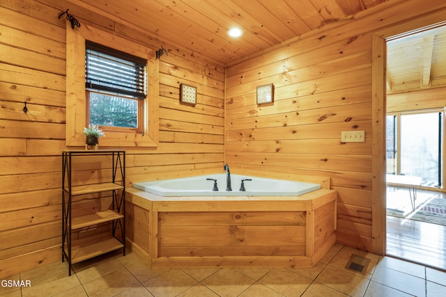 bathroom featuring wood ceiling, a wealth of natural light, a tub, and wood walls