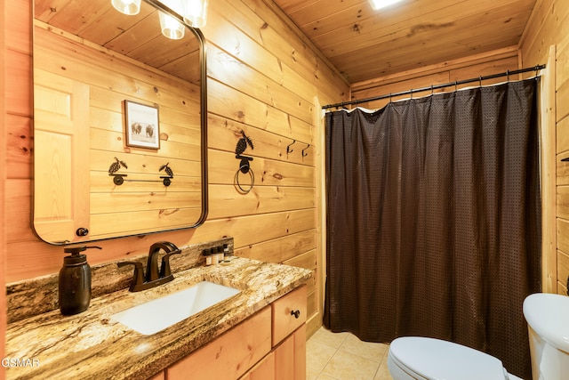 bathroom with tile patterned floors, vanity, wooden ceiling, toilet, and wood walls