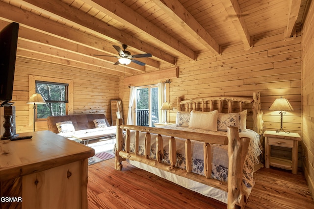 bedroom featuring beamed ceiling, wood walls, wooden ceiling, and multiple windows