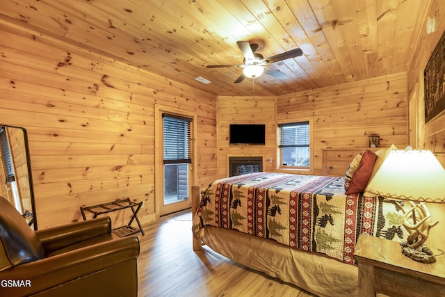 bedroom featuring hardwood / wood-style flooring, ceiling fan, and wood ceiling