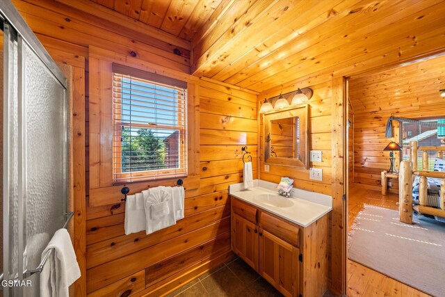 bathroom with tile patterned flooring, vanity, wooden ceiling, and wooden walls