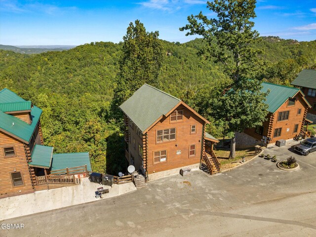 birds eye view of property featuring a forest view