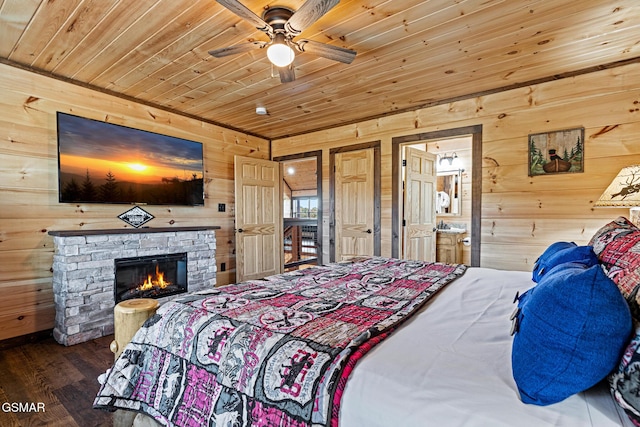 bedroom with ceiling fan, wood-type flooring, wood ceiling, and wooden walls