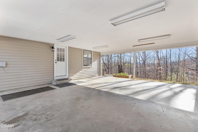 view of patio featuring entry steps and a carport