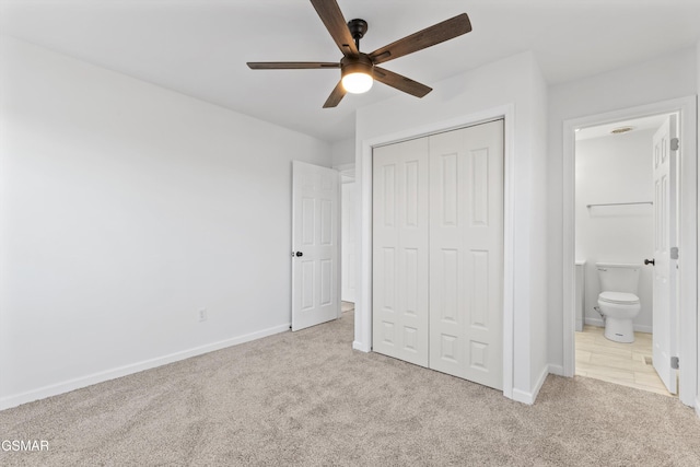 unfurnished bedroom with a closet, carpet flooring, and baseboards