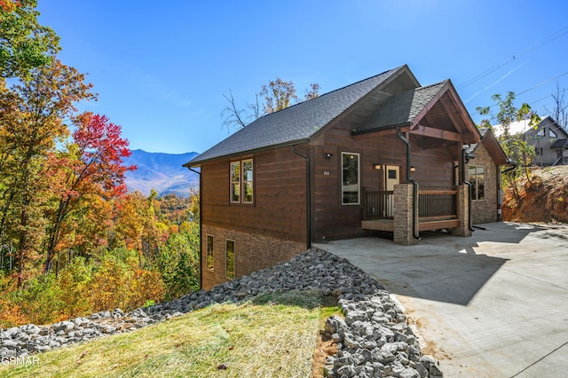 view of side of home with a mountain view